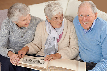 Image showing Old people, friends and photo album for memory nostalgia in retirement on sofa together, photograph or connection. Elderly man, women and picture book in home in Canada for bonding, remember or love