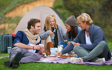 Image showing Nature, camping and people on picnic with food laughing, talking and bonding on vacation. Happy, travel and group of friends eating lunch in outdoor field, park or forest on holiday or weekend trip.