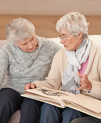 Image showing Elderly women, photo album and memory nostalgia in retirement or together, photograph or connection. Old people, photography and picture book in apartment for remember past, bonding or conversation