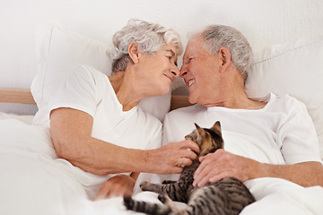 Image showing Senior couple, bed and cat for bonding, embrace and love in morning for smile and cuddle. Mature man, woman and kitty pet, happy and retirement to enjoy marriage and old people in bedroom at home