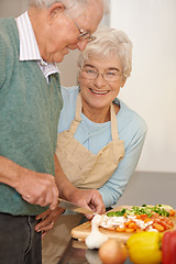 Image showing Senior couple, cutting vegetables and cooking together in kitchen, food preparation and love at home. Elderly people, healthy meal and organic ingredients for nutrition, conversation and retirement