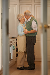 Image showing Elderly, couple and happy with dancing in kitchen for bonding, support and holding hands with romance. Senior, man and woman with hug, embrace and smile for relationship, dancer and love in home