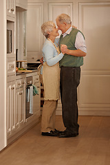 Image showing Senior, couple and love with dancing in kitchen for bonding, support and holding hands while cooking. Elderly, man and woman with hug, embrace and smile for relationship, dancer or happiness in home