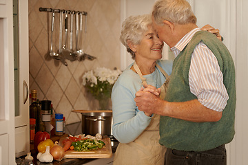 Image showing Senior, couple and smile with dancing in kitchen for bonding, support and holding hands while cooking. Elderly, man and woman with hug, embrace or happiness for relationship, dancer and love in home