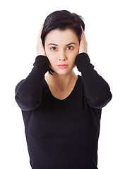 Image showing Portrait, loud and woman covering ears, stress and person isolated on a white studio background. Face, model and girl with sound or noise with problem and frustrated with sensitivity and panic attack