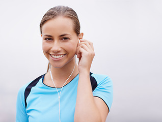 Image showing Portrait, smile and music with runner woman outdoor in misty mountains for fitness or cardio workout. Face, exercise and running with happy young athlete training listening to audio sound in morning