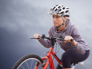 Image showing Woman, bike and nature with cycling, speed and fitness for health and wellness or workout. Athlete, ride and exercise for training, transportation and adventure with helmet and cardio or confidence