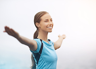 Image showing Freedom, smile and running with sports woman outdoor in mountains for morning cardio training. Exercise, fitness and thinking with happy young runner or athlete getting ready for workout in mist