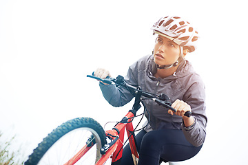 Image showing Woman, bike and nature with cycling, workout and fitness for health and wellness or speed. Athlete, ride and exercise for training, transportation and adventure with helmet and cardio or perseverance