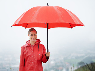 Image showing Woman, portrait and umbrella for security, outdoor nature and protection from rain in weather. Female person, insurance and safety or shield from storm, winter and travel to Scotland for holiday