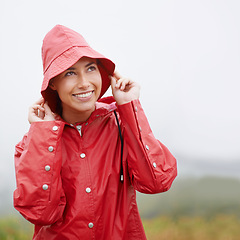 Image showing Woman, smile and raincoat for protection, outdoor nature and waterproof jacket for rain or weather. Female person, happy and safety or shield from cold, winter and travel to Scotland for holiday