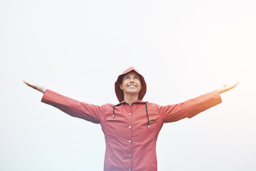 Image showing Happy woman, rain jacket and freedom with hood for weather, cloudy sky or winter season in outdoor storm. Female person with smile in red waterproof raincoat for overcast, fog or snow on mockup space