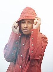 Image showing Woman, portrait and rain jacket with hood for weather, cloudy sky or winter season in outdoor storm. Face of female person or young model with red waterproof raincoat for rainy overcast, fog or snow