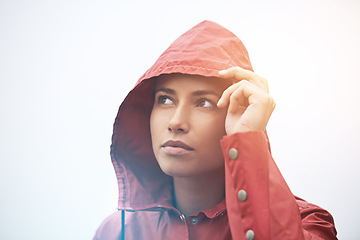 Image showing Woman, rain jacket and thinking with hood for weather, cloudy sky or winter season in outdoor storm. Face of female person with red waterproof coat in wonder for rainy overcast or fog on mockup space