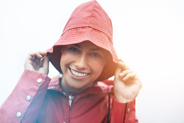 Image showing Happy woman, portrait and red rain jacket with hat for weather, cloudy sky or winter season in outdoor storm. Face of female person with waterproof coat and smile for protection, fog or cold overcast