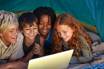 Image showing Laptop, happy and children in tent for camp watching movie, film or show online together. Smile, technology and young kids bonding, relax and streaming video on internet with laptop on weekend trip.