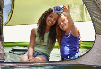 Image showing Happy girl, friends and selfie in tent for memory, camping or photography together with camera. Young female person, child or kids with smile for picture, photo or social media in relax or friendship
