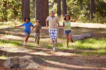 Image showing Nature, adventure and group of kids in forest playing, running and exploring together. Bonding, field and young children for discovery in outdoor woods in summer on vacation, holiday or weekend trip.