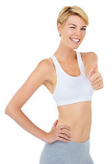 Image showing Portrait, wink and woman with thumbs up for fitness with emoji isolated on a white studio background. Smile, sport and person with like hand gesture for success, exercise and workout for healthy body