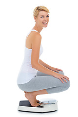 Image showing Woman, portrait and on scale in studio for weight loss, healthcare and wellness for vitality. Female person, diet and check calories for slim body for self care and happy on a white background