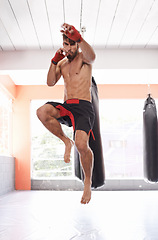 Image showing Man, portrait and jump for kickboxing in gym, fitness and topless for exercise and workout. Male person, bodybuilder and muay thai for challenge or practice, training and boxing for competition