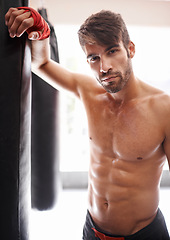 Image showing Man, portrait and ready for boxing in gym, fitness and topless for exercise and workout. Male person, bodybuilder and punching bag for challenge or practice, training and serious face for competition