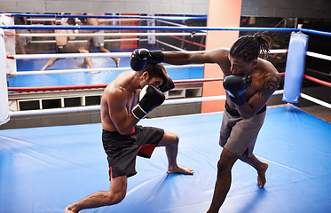 Image showing Men, fighting and boxing ring with punch for competition in gym for endurance development, performance or training. Male people, gear and combat sport together for cardio battle, defence or practice