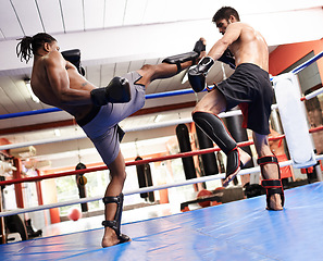 Image showing Kickboxing, fight and men training in gym for fitness and sport, coach and athlete with workout and action. Energy, challenge and MMA with athlete together in ring for boxing, exercise and endurance