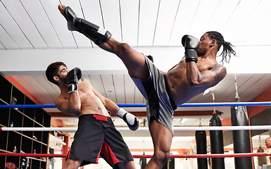 Image showing Kickboxing, fight and men training for sport and fitness in gym, coach and athlete with workout and action. Energy, challenge and MMA with athlete together in ring for boxing, exercise and endurance