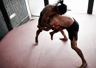 Image showing Fight, wrestling and men in cage for kickboxing competition, challenge and fitness with sports in gym. Match, strong fighter and resilience in exercise, sparring practice and power in battle together