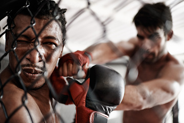 Image showing Punch, pain and men sparring in cage for kickboxing competition, challenge and fitness with fight in gym. Boxing match, strong fighter and knockout with exercise, practice or power in battle together