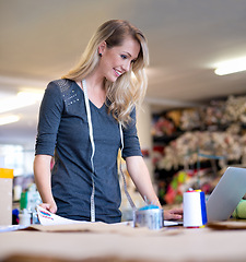 Image showing Business, woman and designer with laptop for fashion, fabric research or web design concept at work. Creative, person or happy tailor with technology for online pattern, inspiration or sewing textile