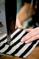 Image showing Sewing, fabric and hands of person at machine with textile, fashion and process closeup in factory. Manufacturing, clothes and creative designer or tailor work with industrial embroidery technology