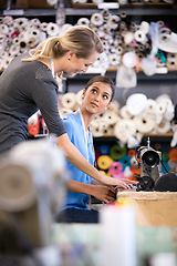 Image showing Sewing, machine and training woman in workshop, learning to work with fabric and process in fashion. Tailor, mentoring or help manufacturing clothes in small business with teamwork in factory