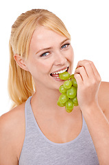 Image showing Studio, woman and portrait with eating grapes for vitamin c, vegan and diet for wellness. Food, face and happy person with fruit for detox, gut health and nutrition benefits on white background