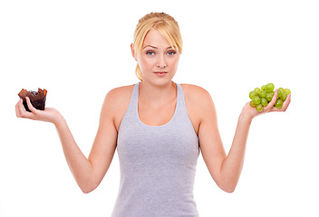 Image showing Woman, confused and dessert or fruit in studio with white background in backdrop. Girl, choice and decision between muffin or grapes for nutrition in food, care and healthy diet for weight loss