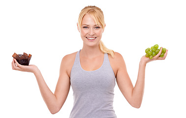 Image showing Portrait, smile and woman with choice of fruit, chocolate or healthy eating food to lose weight in studio. Happy, face and girl with apple vs candy, decision for diet or nutrition on white background