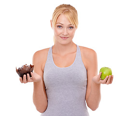 Image showing Portrait, doubt and woman with choice of cake, apple or healthy eating food to lose weight in studio. Benefits, face and girl with fruit vs dessert, decision for diet or nutrition on white background