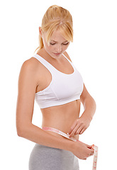 Image showing Woman, stomach and tape in studio for weight loss, measuring and fitness for health. Female person, results on progress and nutrition for slim body, abdomen and workout isolated with white background