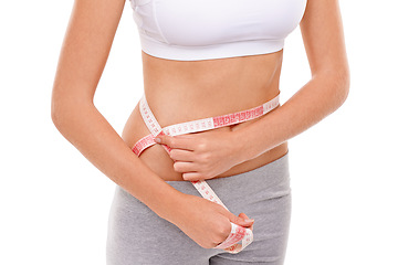 Image showing Woman, stomach and measure in studio for health, fitness and track for weight loss. Female person, results on progress and nutrition for slim body, abdomen and workout isolated with white background