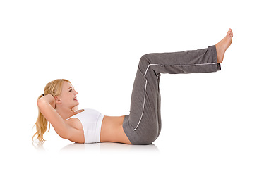 Image showing Woman, yoga and sit ups on floor in studio for exercise, healthy body or wellness with fitness, smile or flexibility. Pilates, person and warm up with sportswear for core strength on white background