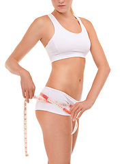 Image showing Measuring tape, fitness and body of woman in studio for diet, workout or weight loss results. Health, wellness and closeup of female person with tool to measure hips or butt by white background.