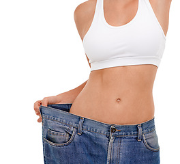 Image showing Jeans, stomach and woman in studio with weight loss for health benefits, diet and fitness goals. Female person, pants and body transformation on white background for progress, results and comparison