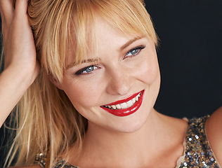 Image showing Closeup, woman and red lipstick with smile for beauty, glamour and makeup on black background. Confident female person, lips and classy cosmetics with glow, happiness and elegance on mockup in studio