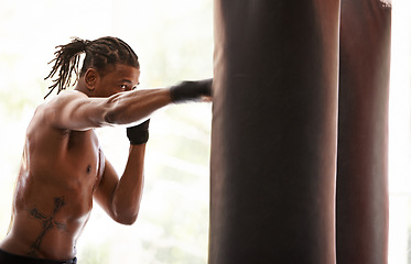Image showing Workout, punching bag and black man boxing in gym for exercise, sports challenge or competition training. Power, muscle and champion boxer at workout with confidence, fight and energy in fitness club