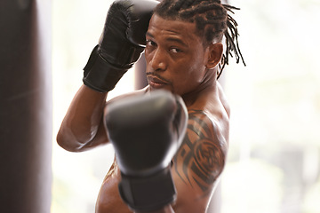 Image showing Fitness, portrait and black man with boxing gloves in gym for challenge, fight and competition training. Power, muscle and serious face of champion boxer at workout with confidence in sports club.