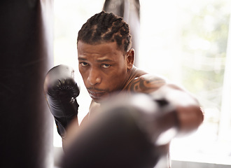 Image showing Punch, portrait and black man with boxing gloves in gym for fitness challenge, fight and competition training. Power, fist and serious face of champion boxer at workout with confidence in sports club