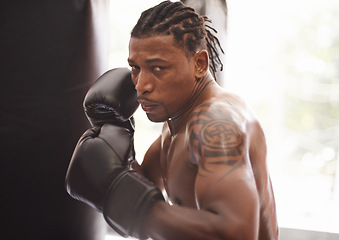 Image showing Challenge, portrait and black man with boxing gloves in gym for fitness, fight and competition training. Power, muscle and serious face of champion boxer at workout with confidence in sports club.