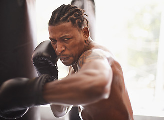 Image showing Battle, portrait and black man with boxing gloves in gym for challenge, fight and competition training. Power, muscle and serious face of champion boxer at workout with confidence in sports club.