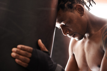 Image showing Boxing, fatigue and black man with punching bag in gym for challenge, fight and competition training. Power, muscle and exhausted champion boxer at workout with tired face, thinking and sports club.